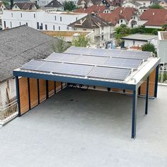 solar panels on the roof of a building in a residential area with houses and rooftops