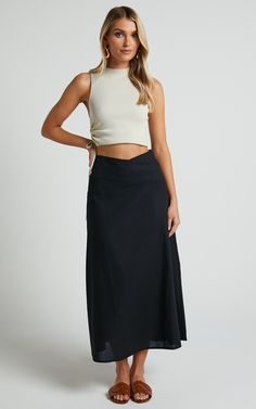 Get ready to turn heads in this flirty and playful Sundry Midi Skirt! With its linen look fabric and high-waisted design, this A-line skirt is perfect for casual days out or dressed up for a night on the town. The cross-front detail adds a touch of sassiness to your outfit, while the black color ensures versatility. Whether you pair it with a crop top or a cozy sweater, this midi skirt is sure to become your new go-to piece for effortless style. So why wait? Embrace your inner fashionista and st Relaxed High-waist Maxi Skirt For Day Out, High Waist Relaxed Maxi Skirt For Day Out, Relaxed High Waist Maxi Skirt For Day Out, Asymmetrical Relaxed Wrap Skirt For Night Out, Relaxed Asymmetrical Wrap Skirt For Night Out, Fitted Pleated Maxi Skirt For Vacation, Fitted Gathered Maxi Skirt For Day Out, Chic Spring Wrap Skirt With Gathered Detail, Elegant Asymmetrical Skort For Day Out