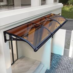 an awning on the side of a house with tiled flooring and white walls