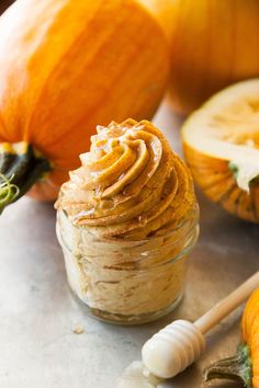 a jar filled with peanut butter next to pumpkins