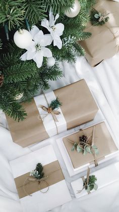 presents wrapped in brown paper and tied with twine, sitting under a christmas tree