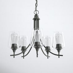 a chandelier with five clear glass shades