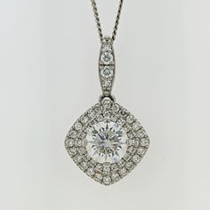 This piece is luxuriously crafted in solid 14k white gold and the natural diamonds radiate gracefully from the mounting. They also beautifully highlight the gorgeous round center colorless moissanite.   Add shimmer to your day or evening look with this double halo moissanite & diamond pave pendant.  The chain is included in the price. * Description: *Length: 13mm (without bail) * Metal purity: solid 14k white gold *Center Stone:6.5mm (DEW 1ct) moissanite * Center Stone Quality: VS-VVS clarity an Diamond White Necklace With Halo Setting And Round Stone, Exquisite Diamond White Solitaire Necklace With Diamond Accents, White Sterling Silver Diamond Necklace With Halo Setting, Dazzling Diamond White Necklace With Prong Setting, White Diamond Halo Necklace In Sterling Silver, Dazzling Platinum Diamond Necklace, Dazzling Diamond White Necklace With Halo Setting, Fine Jewelry Diamond White Necklace With Halo Setting, Diamond Necklace With Halo Setting