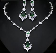 Not sold in Stores! Who doesn't love to dress up in their finest and flirt their style? This is perfect for an evening soiree, wedding, or party night. You'll come up with an occasion for sure! This Luxe Cubic Zirconia Necklace Earring Set - comes in a variety of simulated stones: Emerald Green/ Sapphire Blue or Wizard White. Make your evening cocktail dress or ball gown stand out even more. We know you'll wear it so well! Included Additional Item Description: * 1 pair Drop Earrings in your choice of 3 beautiful colors * 1 pc Necklace in your choice of 3 beautiful colors Earrings Length: 5.6 cm or 2-1/4" in. approx. Empress Drop Earrings Matching Choker Necklace: 43 cm or 17" in approx. Shop with confidence with our secure checkout: Apple Pay-Mastercard-Visa & PayPal FREE SHIPPING! Please Elegant Jewelry Sets With Jewels For Party, Elegant Bridal Necklace With Jewels And Cubic Zirconia, Elegant Crystal Jewelry Sets For Party, Elegant Hand Set Bridal Necklace For Evening, Elegant Bridal Necklace For Evening, Hand Set, Elegant Evening Jewelry Sets With Jewels, Silver Jewelry Sets With Diamond Accents For Party, Elegant Crystal Jewelry Sets For Evening, Elegant Evening Jewelry Sets With Diamond Accents