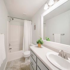 a bathroom with a sink, toilet and bathtub