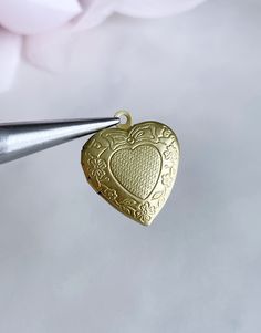 These engraved heart-shaped brass lockets are perfect for all kinds of jewelry projects including earrings, bracelets and necklaces.  I personally hand polish all brass pieces before sending them to my customers, so they will be clean, bright and ready to use! 23mm x 18mm 2 pieces Valentine's Day Antique Gold Locket Necklace With Vintage Charm, Vintage Heart Locket Necklace Nickel Free, Antique Gold Heart Locket Necklace With Vintage Charm, Antique Gold Heart Locket Necklace For Valentine's Day, Heart-shaped Antique Gold Locket Necklace For Valentine's Day, Valentine's Day Heart-shaped Locket Necklace In Antique Gold, Brass Heart Locket Necklace With Charm, Antique Gold Heart Locket Necklace, Brass Heart Pendant Locket Necklace With Charm