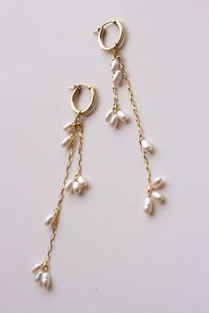 Completely handcrafted in our New York studio, the Falling Petals Mini Hoop Earrings feature genuine freshwater pearls. Lightweight and easy to wear. Wear them two ways - slide the dangle off to wear just the simple hoop earring. Ear wires: hoop Materials: 14k Gold Filled or Sterling Silver Measures approx. 3 3/4" (longest strand) in length Handmade in New York Arrives in a keepsake clutch and box Gold Earrings With Pearls, Simple Earrings Design, Easy To Make Earrings, Handmade Drop Earrings, Handmade Earrings Ideas, Pearl And Gold Earrings, Handmade Jewelry Ideas, Handmade Pearl Earrings, Simple Gold Jewelry