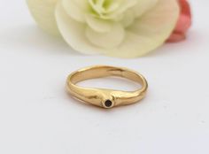 "Minimalist 14k yellow gold ring for women with a beautiful black diamond or another gem of your choosing, an alternative modern engagement ring.  This dainty solid gold ring is one of my first designs and holds a warm spot in my heart. It has a single beautiful black diamond set in a tiny horn-like design. As a hand-made item, this ring has a bit of light raw texture and is full of character. The color combination of black and gold and the amorphic and minimalist design make this ring both classic and daring. Unique.  This ring is delicate and comfortable to wear and will be great for everyday and special occasions.  It can also be a great modern engagement ring. If you are looking for a gift for a classic woman with a modern spark - this is the perfect ring.  Features: * One 14K solid go Black Diamond Ring Set, Minimalist Gold Ring, Raw Texture, Modern Engagement Rings, Gold Gemstone Ring, Solid Gold Ring, Black Diamond Ring, Ring Minimalist, Solid Gold Rings