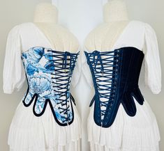 This corset is inspired by the classic shape with a few modern twists, designed to be worn with a V shape in the front it is reversible in nature with one side being a Blue Floral Bird Cotton and Ink Blue Velvet  Laced with a matching 4m cotton cord in a way that facilitates the swapping between the two sides with ease.  A fabulous addition to any wardrobe and made of 60% recycled fabrics This stays style corset is designed to be worn with a gap in the front Size M Bust 31" Waist 28" I recommend Blue Corset With Boned Bodice, Blue Corset Dress With Fitted Bodice, Blue Fitted Underbust Corset Dress, Blue Fitted Corset Dress For Costume, Blue Underbust Corset With Fitted Bodice, Blue Overbust Corset With Boned Bodice, Blue Fitted Corset With Corset Back, Fitted Blue Corset With Corset Back, Blue Underbust Corset With Boned Bodice