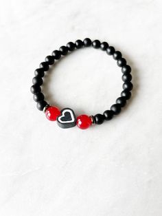 OVERVIEW **This heart bracelet is made with 6mm matte black beads, 6mm red glass beads, and a black polymer clay heart bead, set on stretchy cord. Approx. 7 inches ** Custom designed and made in USA. LOOKING TO STACK YOUR BRACELETS? More bracelets can be found here: https://www.etsy.com/shop/CarbonAndCopper?section_id=18041311 SHIPMENT & DELIVERY **All jewelry comes in a custom linen bag and shipped in a white padded envelope. **This bracelet is made and ready to be shipped to you within 5-7 days of purchase. **Domestic Shipping is approximately 3-5 business days using USPS First Class Mail **For more Shipping information, please see link below: https://www.etsy.com/shop/CarbonAndCopper?ref=hdr§ion_id=18041311#policies OTHER INFO ** Please keep in mind there may be some variation in the co Adjustable Black Bracelets For Valentine's Day, Adjustable Black Heart-shaped Bracelet, Adjustable Black Heart Bracelets, Black Friendship Bracelet For Valentine's Day, Handmade Black Bracelets For Valentine's Day, Handmade Black Bracelet For Valentine's Day, Black Heart-shaped Adjustable Beaded Bracelets, Adjustable Beaded Black Heart Bracelet, Adjustable Black Beaded Heart Bracelet