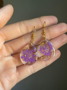 Floral earrings hand made to add a unique and simple pop of color and touch of nature to your favorite outfit. Unique Handmade Plug Earrings, Unique Plug Earrings As Gift, Unique Plug Earrings For Gift, Unique Single Purple Earring, Trendy Purple Flower Earrings For Gift, Trendy Flower Shaped Hoop Earrings Gift, Trendy Handmade Dangle Earrings, Nature-inspired Round Flower Earrings, Bohemian Resin Earrings With Ear Wire