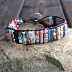 This multi color beaded bracelet for women is stunning and unique. This single wrap bracelet would compliment and outfit you want to wear it with. This bracelet would be a beautiful meaningful gift for your mother on Mother's Day. It will be a gift she can enjoy every day. This leather beaded bracelet is made with a variety of gemstone beads in various sizes and colors. Please choose the size you would like at check out. Beaded Wrap Bracelet For Gift, Adjustable Cuff Bracelet With Colorful Beads As Gift, Adjustable Cuff Bracelet With Colorful Beads For Gifts, Adjustable Hand-strung Cuff Bracelet Gift, Multicolor Beaded Wrap Bracelet As Gift, Bohemian Cuff Bracelet With Hand Wrapped Round Beads, Multicolor Beaded Friendship Wrap Bracelet, Hand-strung Multicolor Bracelets For Friendship, Bohemian Hand Wrapped Cuff Bracelet With Round Beads