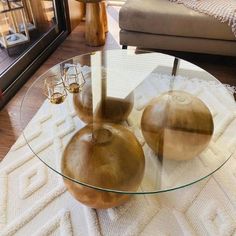 a glass table with two vases on it