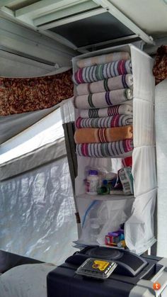 the inside of a tent with several rolls of toilet paper and other items in it