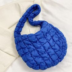 Nylon Puffer Solid Color Purse Tote Handbag Slouch Bag Blue Solid Color Puffer Nylon Slouch Bag. Fun Bright Colors! * 13" X 9.5" * Zipper Closure * 22" Long Strap * Water-Resistant Inner Lining * Zipper Interior Pockets Trendy Packable Nylon Shoulder Bag, Blue Quilted Nylon Bags, Blue Packable Tote Shoulder Bag, Blue Quilted Shoulder Bag For Everyday Use, Trendy Blue Quilted Bag, Blue Nylon Shoulder Bag For Travel, Blue Quilted Travel Bags, Packable Blue Nylon Bag, Blue Quilted Tote Shoulder Bag