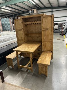 a wooden table and bench in a warehouse