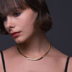 Introducing the stunning Foxy Necklace, the perfect accessory for anyone looking to add a touch of elegance and sophistication to their wardrobe. Made from high-quality 18k gold plated brass, this necklace is both luxurious and durable, ensuring it will last for years to come. With a length of 16 inches and a 1-inch extender, this necklace is adjustable to fit most neck sizes comfortably. Its sleek and shiny design is eye-catching yet subtle, making it the perfect accessory for any occasion, fro Formal Clavicle Snake Chain Necklace, Elegant Gold Chain Choker For Formal Events, Elegant Gold Chain Choker For Formal Occasions, Classic Clavicle Chain Necklace For Everyday Luxury, Elegant Gold Snake Chain Choker, Elegant Gold Choker With Clavicle Chain, Elegant Gold Herringbone Necklace With Adjustable Chain, Elegant Snake Chain Choker With Adjustable Chain, Elegant Gold Chain Choker As Gift