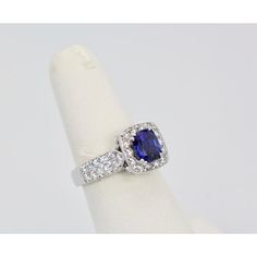 This is part of Chairish’s Fine Jewelry assortment.  Burma Sapphire Ring with Diamond Surround 18k  Everybody loves a nice Blue Sapphire ring. This one is from Burma and the Sapphire is set with a Diamond Surround. It is a gorgeous deep Blue with magnificent sparkle. The color is absolutely wonderful, true Sapphire Blue. The Sapphire has some heating and it weighs 1.25 Carats. There is also 2 Carats of Diamonds in the surround. The Diamonds are G in color and VS2. So, the ring is 3.25 Carats but Exquisite Diamond Cut Sapphire Ring, Exquisite Diamond-cut Sapphire Ring, Luxury Sapphire Ring With Round Stone, Luxury Lab-created Sapphire Gemstone Ring, Sapphire Cushion Cut Ring With Center Stone, Cushion Cut Lab-created Sapphire Ring In Fine Jewelry Style, Timeless Sapphire Cluster Ring With Prong Setting, Luxury Round Sapphire Ring, Platinum Diamond Ring With Round Cut Gemstone