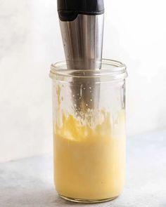 a blender filled with yellow liquid on top of a counter