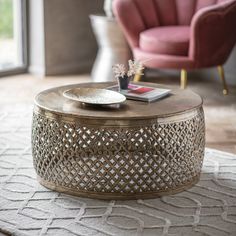 a living room with a couch, chair and coffee table on top of a rug