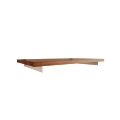 a wooden shelf with white legs on a white wall