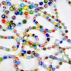 Crafted by skilled artisans in Murano, Italy, each bead of our Millefiori beaded necklace is handcrafted to perfection, creating a unique piece of jewelry. Inspired by the centuries-old Murano glassmaking tradition, these beads showcase intricate patterns and vibrant colors. The Millefiori technique involves fusing together multiple glass canes, resulting in mesmerizing floral designs that are truly one-of-a-kind. Choose from two necklaces, our large bead long necklace, or the small bead necklac Artisan Beaded Necklaces With Spacer Beads As Gift, Murano Glass Beaded Necklace As Gift, Adjustable Murano Glass Beaded Necklace For Gifts, Handmade Glass Beads For Jewelry Making, Artisan Beaded Chain Bracelet Gift, Artisan Beaded Chain Bracelets As Gift, Round Beaded Necklace With Spacer Beads As Gift, Gift Round Spacer Beads Necklace, Artisan Glass Beads For Gifts