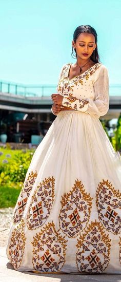 This gorgeous Habesha dress for a wedding is a breathtaking ensemble that showcases the beauty of Ethiopian traditions and celebrates the joyous union of two souls. Meticulously crafted with handwoven fabric, intricate embroidery, Menen fabric, and thread design, it exudes elegance and grace. The foundation of this dress lies in the handwoven fabric, a testament to the skill and artistry of Ethiopian weavers. Using traditional techniques, they intricately weave luxurious cotton or silk threads t Ethiopian Textiles, Eritrean Dress, Habesha Dress, Habesha Kemis, Dress For A Wedding, Thread Design, Two Souls, Delicate Embroidery, Handwoven Fabric