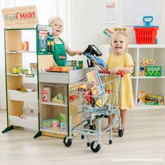 two children playing with toys in a playroom