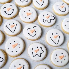 decorated cookies are arranged in the shape of snowmen