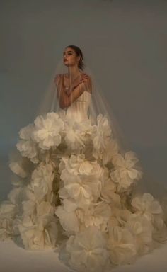 a woman in a wedding dress with flowers on it