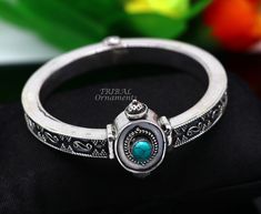 Handcrafted 925 sterling silver fabulous turquoise bangle bracelet kada. fabulous attractive design work silver jewelry with amazing locking system, excellent wedding or party jewelry/gifting jewelry from India. Metal-925 sterling silver. Type-Bangle/bracelet/kada. Width of bangle-0.8 centimeter. Size-2-6 or 2.375 inches or 6.0 cm inner diameter(2-6/2-7 comfort with both sizes) Weight-53.960 grams approx. for single bangle. Stamped-925. stone part width-3.2 centimeters. Finish-Oxidized. Stone-Tu Silver Openable Bangle Jewelry, Openable Silver Bangle Jewelry, Silver Openable Bracelets As A Gift, Silver Openable Bracelets For Gift, Silver Openable Bracelet For Gift, Openable Bracelet Jewelry Gift, Silver Gemstone Bracelets For Festivals, Single Bangle, Turquoise Bangle