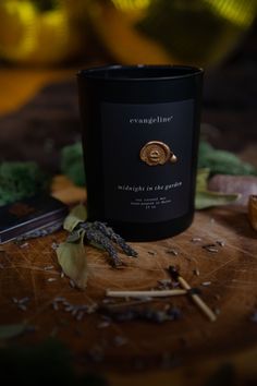 a candle sitting on top of a wooden table next to some leaves and other items