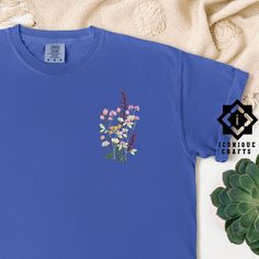 Comfort Colors Flower Embroidered Shirt, Floral Tee, Floral Sweatshirt, Flower T-shirt, Wild Flower sweatshirt, Wildflower Tee, Gift for her This listing is for an embroidered shirt, making it a luxurious choice. Embroidery adds a premium, tactile quality to your item, offering a more refined and durable finish compared to other methods. Explore more fun and unique designs at https://www.etsy.com/shop/iconiquecrafts/ SHIPPING TO HAWAII OR ALASKA Please contact us before ordering if you live in A Blue T-shirt With Embroidered Text For Spring, Blue Crew Neck Tops With Floral Embroidery, Blue Crew Neck Top With Floral Embroidery, Blue Floral Embroidered Crew Neck Top, Relaxed Fit Crew Neck Tops With Floral Embroidery, Casual Crew Neck Shirt With Machine Embroidery, Cotton Floral Embroidery Short Sleeve Shirt, Cotton Short Sleeve Shirt With Floral Embroidery, Relaxed Fit Floral Embroidery Tops With Crew Neck