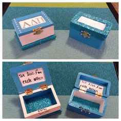 two boxes with wedding rings in them sitting on top of a blue tablecloth covered floor