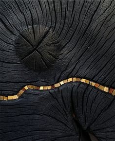 a wooden structure with a snake on it's side