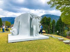 a sculpture in the middle of a grassy area