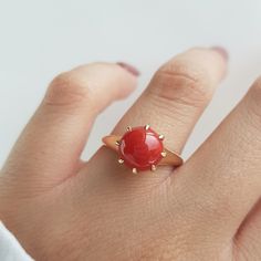 RING DETAILS: ✪Design: Gold ring ✪Gemstone: Natural coral ✪Gemstone color: Red ✪Gemstone size: 9mm Gemstone weight: 2.15mm ✪Gemstone shape: Round ✪Setting type: Prong Gold weight: 2 gram ✪Metal type: 14k solid yellow gold ✪Metal finish: Smooth shiny Choose your ring size from drop down menu and if you need any other preferred ring size please contact us. QUALITY OF MATERIALS: Metal: Most of our jewelry at JewelryMansion is made with precious metals like gold and silver. These metals are 100% non Red Cabochon Ruby Ring In 14k Gold, 14k Gold Red Cabochon Ruby Ring, 14k Gold Red Cabochon Ring, 14k Gold Rings With Red Cabochon, 14k Gold Cabochon Red Ring, Red Jewelry With Round Stone In Prong Setting, Red Round Jewelry With Prong Setting, Elegant Red Crystal Round Ring, Elegant Red Round Crystal Ring