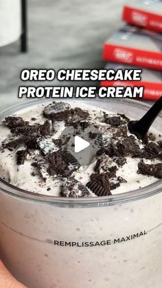 an ice cream dessert with oreo cheesecake and protein ice cream in it is being held up by someone's hand