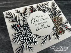 a handmade christmas card with pine cones and red berries on it, which reads may this be a christmas to remember jesus