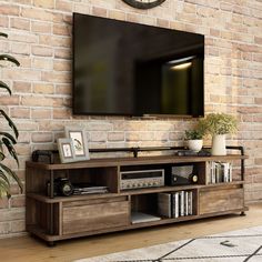 a flat screen tv mounted to the side of a brick wall in a living room