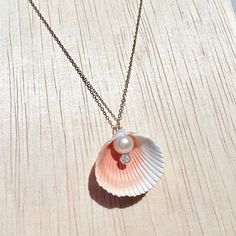 Picked from the beaches of south Florida, a beautiful cockle shell with mauve and rose tones inside, holding an ivory pearl with a sparkling cubic zirconia stone beneath. Choose between 14k gold filled, 14k rose gold filled, or sterling silver. 16" long. *I find all my shells while searching along the beach - I never take from the ocean. Because no two shells are exactly identical, slight variations in size and color are to be expected, but I only use shells that are as close as possible to the Elegant Shell-shaped Rose Gold Jewelry, Elegant Rose Gold Shell-shaped Jewelry, Elegant Pink Shell Jewelry, Hammered Necklace, Rose Tone, Ivory Pearl, Shell Jewelry, Opal Necklace, Custom Necklace