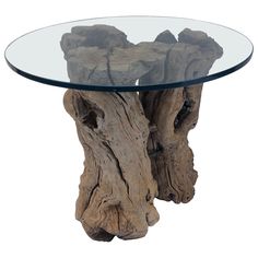 a glass and wood table with some rocks on the top, in front of a white background