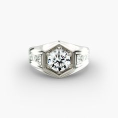 a white gold engagement ring with diamonds on the sides and an octagonal cut diamond in the center