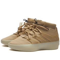 adidas and Fear of God Athletics introduce the 'Clay' rendition of the I Basketball silhouette, marking another milestone in their groundbreaking collaboration. Blending fashion and sports seamlessly, these kicks feature a sleek low profile, knit upper, and neoprene collar all in an understated muted colour palette, a signature of Jerry Lorenzo, while the 3-Stripes moulded cage design is inspired by adidas Predator cleat archive..Knit Upper.Neoprene Collar.3D Moulded Cage.Lightstrike Cushioning.Ankle Toggle Bungee.adidas Logo Embossed At Toe.Fear of God Logo On Black Bar.Translucent Rubber Outsole Adidas Custom Sneakers With Translucent Outsole For Streetwear, Adidas Custom Sneakers For Streetwear With Translucent Outsole, Dynamic High-top Sneakers With Translucent Outsole For Streetwear, Streetwear Basketball Shoes With Textured White Sole, Adidas Sneakers With Boost Midsole For Streetwear, Modern Adidas Lace-up Sneakers, Dynamic High-top Sneakers With Boost Midsole For Streetwear, Modern High-top Sneakers With Boost Midsole For Streetwear, Modern Adidas Sneakers For Light Sports