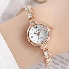 Rhinestone & Heart Quartz Bracelet Watch Round Dial Wristwatch Very Pretty Watch For Any Occasion Or Gift For Your Loved Ones. Dial: Round White Watch Diameter: 0.87 In Band Width: 0.24 In Band Length: 7.8 In Weight: 28g Stock Id: Tjb47-Wa04 Rose Gold Alloy Watch Perfect For Gift, Rose Gold Alloy Watch As Gift, Elegant Silver Watch For Valentine's Day, Valentine's Day Elegant Silver Watch, Rose Gold Watch With Rhinestones As Gift, Round Crystal Watch As Gift, Rose Gold Watches With Rhinestones For Gifts, Crystal Watch As A Gift, Rose Gold Rhinestone Watch As Gift