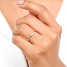 a woman's hand with a gold ring on it