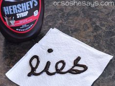 a bottle of hershey's syrup next to a napkin with the word yes on it