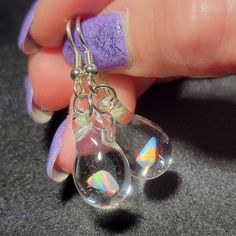 "My friend Marcy named this style of earrings. She said they look like Mermaid's tears. These teardrop dangle earrings are crafted by melting borosilicate glass tubing (pyrex) and blowing a bubble at the end of the tube in the flame, encasing a white Gilson opal nugget inside. The opal flashes with blue, green, yellow, and red hues within the glass. Only first-quality borosilicate glass and a blowtorch fueled by oxygen and propane are used, and the pieces are annealed in a digitally controlled e Nickel-free Glass Drop Jewelry, Nickel-free Teardrop Glass Jewelry, Nickel-free Glass Teardrop Jewelry, Hypoallergenic Teardrop Glass Jewelry, Glass Teardrop Jewelry With Matching Earrings, Glass Drop Earrings With Matching Set, Hypoallergenic Glass Teardrop Jewelry, Nickel-free Teardrop Spiritual Jewelry, Spiritual Teardrop Nickel-free Jewelry