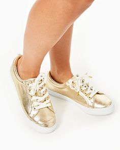 Leather lace up sneaker with gold metallic and pave rhinestone accents. Solid Nappa Leather. Imported. | Women's Lux Hallie Sneaker in Gold | Size 7 - Lilly Pulitzer Gold Leather Low-top Sneakers, Gold Lace-up Sneakers With Metallic Logo, Gold Low-top Sneakers With Metallic Logo, Gold Leather Sneakers With Laces, Gold High-top Sneakers With Vulcanized Sole, Gold High-top Sneakers With Perforated Toe Box, Casual Gold Lace-up Sneakers, Gold Leather Sneakers, Trendy Gold Low-top Sneakers