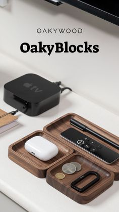 an apple watch, wallet, and other items are sitting on a desk with the words oaky blocks above them